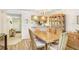 Comfortable dining room with hardwood floors, chandelier, and kitchen view providing a relaxed and inviting space for meals at 172 Lakeview Way # 172, Oldsmar, FL 34677