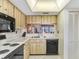 Efficient kitchen layout with ample countertop space, essential appliances, and view to adjacent room, creating an open feel at 172 Lakeview Way # 172, Oldsmar, FL 34677