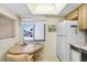 Bright kitchen nook with table, offering a cozy spot for casual dining, with a street view window, and white refrigerator at 172 Lakeview Way # 172, Oldsmar, FL 34677