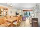 Open-concept living area featuring fireplace, adjacent dining, and sliding glass doors with picturesque views offering a seamless flow at 172 Lakeview Way # 172, Oldsmar, FL 34677