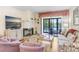 Relaxing living room with fireplace, balcony access, and comfortable seating, providing a cozy space for relaxation and entertainment at 172 Lakeview Way # 172, Oldsmar, FL 34677