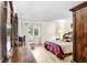 Serene primary bedroom with natural light, wood-look flooring, and ample closet space, creating a tranquil retreat at 172 Lakeview Way # 172, Oldsmar, FL 34677