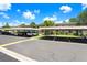 Exterior view of the community's parking with covered spaces and lush green landscaping at 172 Lakeview Way # 172, Oldsmar, FL 34677