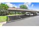 Well-maintained community parking area with covered spaces and manicured lawn at 172 Lakeview Way # 172, Oldsmar, FL 34677
