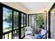 Enclosed sunroom with views of the tranquil lake and lush greenery, perfect for relaxing at 172 Lakeview Way # 172, Oldsmar, FL 34677
