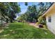 Expansive backyard featuring lush green grass and mature trees, perfect for outdoor enjoyment at 1720 Chrysler Ave, Sarasota, FL 34234