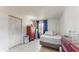 Bedroom with twin bed, wood dresser, closet and natural light from the window at 1720 Chrysler Ave, Sarasota, FL 34234