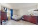 Bedroom with twin bed, wood dresser, closet and natural light from the window at 1720 Chrysler Ave, Sarasota, FL 34234