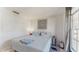 Bright bedroom with a cozy bed, stylish decor, and natural light from the window at 1720 Chrysler Ave, Sarasota, FL 34234