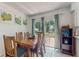 Dining area featuring a wooden table, six chairs, sliding glass door leading to patio at 1720 Chrysler Ave, Sarasota, FL 34234