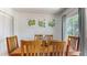 Dining room with a wooden table, six chairs, and art hanging on the wall at 1720 Chrysler Ave, Sarasota, FL 34234