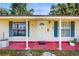 Close up of the front door and porch area with plants and house number visible at 1720 Chrysler Ave, Sarasota, FL 34234