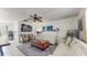 Living area with sofas, ceiling fan, patterned rug, and artwork on the wall at 1720 Chrysler Ave, Sarasota, FL 34234