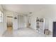 Spacious room with tile floors, multiple doorways, closet and a small shelving unit at 1720 Chrysler Ave, Sarasota, FL 34234