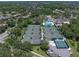 Aerial view of the community tennis courts, pickleball courts, and pool with surrounding trees at 18003 Arbor Crest Dr, Tampa, FL 33647