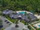 Aerial view of the community clubhouse, pool, parking lot and manicured landscaping at 18003 Arbor Crest Dr, Tampa, FL 33647