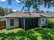 Backyard view with lanai and lush lawn at 18003 Arbor Crest Dr, Tampa, FL 33647