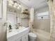 Bright bathroom features a modern vanity, decorative mirror and updated fixtures and shower at 18003 Arbor Crest Dr, Tampa, FL 33647