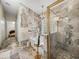 Bright bathroom with marble tile, bathtub, separate shower, and glass block window allowing natural light at 18003 Arbor Crest Dr, Tampa, FL 33647