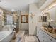 Elegant bathroom featuring marble tiling, a glass-enclosed shower, and a vanity with a stylish mirror at 18003 Arbor Crest Dr, Tampa, FL 33647