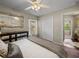 Relaxing bedroom boasts a decorative mirror, ceiling fan, and a view into the hallway at 18003 Arbor Crest Dr, Tampa, FL 33647