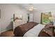 Comfortable bedroom with a large dresser, ceiling fan, and a view to the hallway at 18003 Arbor Crest Dr, Tampa, FL 33647