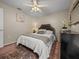 Comfortable bedroom featuring a decorative mirror, ceiling fan, and soft carpet at 18003 Arbor Crest Dr, Tampa, FL 33647