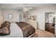 Bedroom boasts neutral walls, ceiling fan, complemented by a view into a warm living space at 18003 Arbor Crest Dr, Tampa, FL 33647
