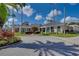 Community clubhouse exterior with manicured landscaping, columns, and covered entrance at 18003 Arbor Crest Dr, Tampa, FL 33647