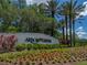 Arbor Greene community sign with flowering shrubs and tall palm trees in the background at 18003 Arbor Crest Dr, Tampa, FL 33647
