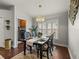 Cozy dining area with elegant chandelier, dark wood table, and nearby laundry room, perfect for Gathering meals at 18003 Arbor Crest Dr, Tampa, FL 33647