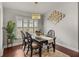 Bright dining room featuring a modern chandelier, stylish decor, and a large window with light filtering through at 18003 Arbor Crest Dr, Tampa, FL 33647