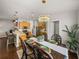 Dining room with elegant chandelier adjacent to a spacious, modern kitchen with stainless steel appliances and island seating at 18003 Arbor Crest Dr, Tampa, FL 33647