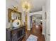 Inviting entryway featuring dark hardwood floors, decorative mirror and light fixture, and an arched opening at 18003 Arbor Crest Dr, Tampa, FL 33647