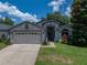 Charming single-story home with well-manicured lawn and mature landscaping at 18003 Arbor Crest Dr, Tampa, FL 33647
