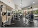 Bright gym with modern equipment, ceiling fan, mirrored wall and windows overlooking the pool at 18003 Arbor Crest Dr, Tampa, FL 33647