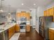 Modern kitchen features stainless steel appliances, wooden cabinets, and seamless transition to living spaces at 18003 Arbor Crest Dr, Tampa, FL 33647