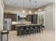 Modern kitchen features a large island with bar seating and stainless steel appliances at 18003 Arbor Crest Dr, Tampa, FL 33647