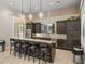 Modern kitchen features a large island with bar seating and a stainless steel refrigerator at 18003 Arbor Crest Dr, Tampa, FL 33647