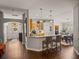 An open-concept kitchen view with bar seating, light wood cabinets, stainless appliances, and adjacent dining area at 18003 Arbor Crest Dr, Tampa, FL 33647
