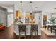 Open kitchen view with a bar, stainless steel appliances, and natural wood cabinets open to dining area at 18003 Arbor Crest Dr, Tampa, FL 33647