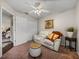 Inviting living room with a comfortable white sofa, decorative ottoman, and convenient closet space at 18003 Arbor Crest Dr, Tampa, FL 33647
