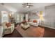 Bright living room featuring neutral walls, ceiling fan, light hardwood floors, and comfortable seating area at 18003 Arbor Crest Dr, Tampa, FL 33647