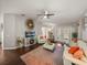 Cozy living room featuring hardwood floors, a ceiling fan, comfortable seating, and a decorative fireplace at 18003 Arbor Crest Dr, Tampa, FL 33647