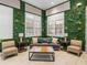 Cozy seating area features a sofa, chairs, and unique floral wall decorations at 18003 Arbor Crest Dr, Tampa, FL 33647