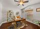 Bright home office featuring hardwood floors, a ceiling fan, and a desk with gold accents at 18003 Arbor Crest Dr, Tampa, FL 33647