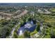 Aerial view of community pond with a fountain, surrounded by homes and lush green trees at 18003 Arbor Crest Dr, Tampa, FL 33647