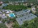 Aerial view of multiple tennis courts alongside the swimming pool and lush greenery offering a variety of recreational options at 18003 Arbor Crest Dr, Tampa, FL 33647