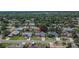 A beautiful aerial view of the house showing its manicured lawn, mature trees, and proximity to other homes at 1801 Sagebrush Rd, Plant City, FL 33566