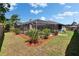 Backyard with pool, screened enclosure, mulch beds and green grass at 1801 Sagebrush Rd, Plant City, FL 33566